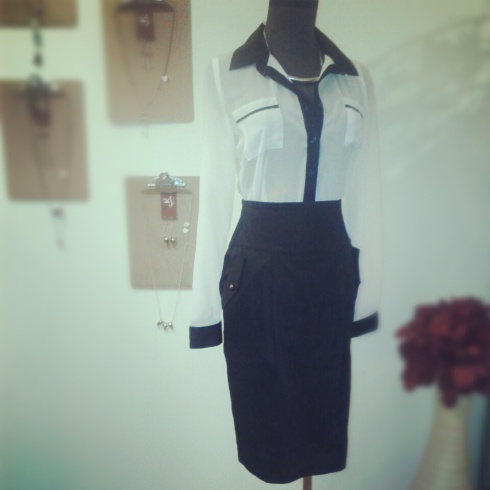 White blouse button up blouse with black piping and high waisted black pencil skirt with button detail on pocket