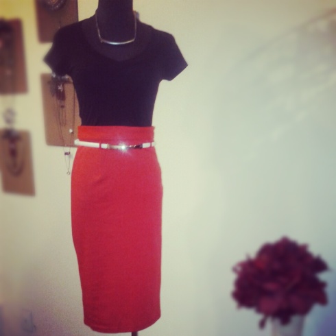 Black v-neck tee with a high waisted fire red pencil skirt, accessorized with white adjustable belt 